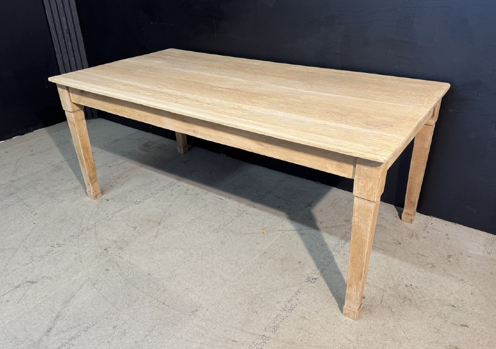 A rectangular light oak dining table featuring clean straight edges, a planked top, and simple tapered legs against a neutral background. View IV