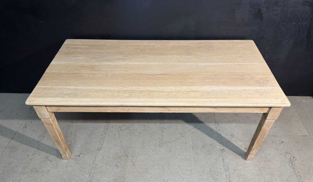 A rectangular light oak dining table featuring clean straight edges, a planked top, and simple tapered legs against a neutral background. View VI