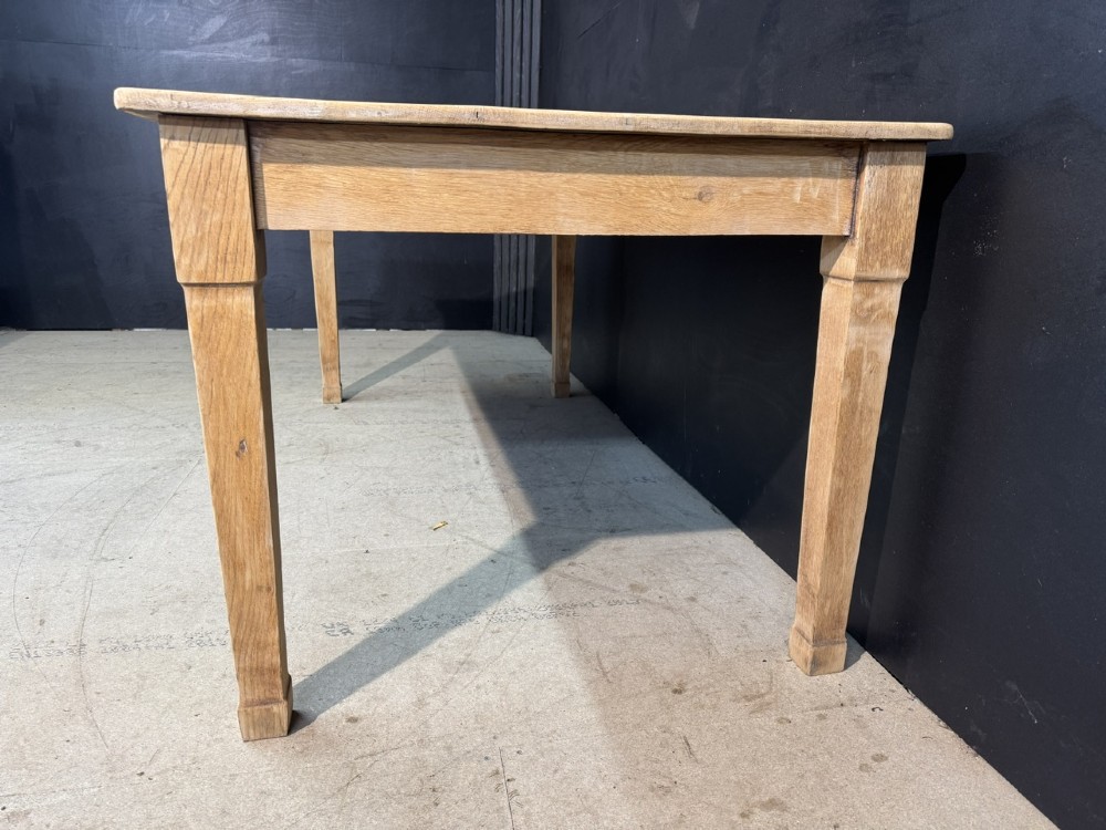 A rectangular light oak dining table featuring clean straight edges, a planked top, and simple tapered legs against a neutral background. View VIII