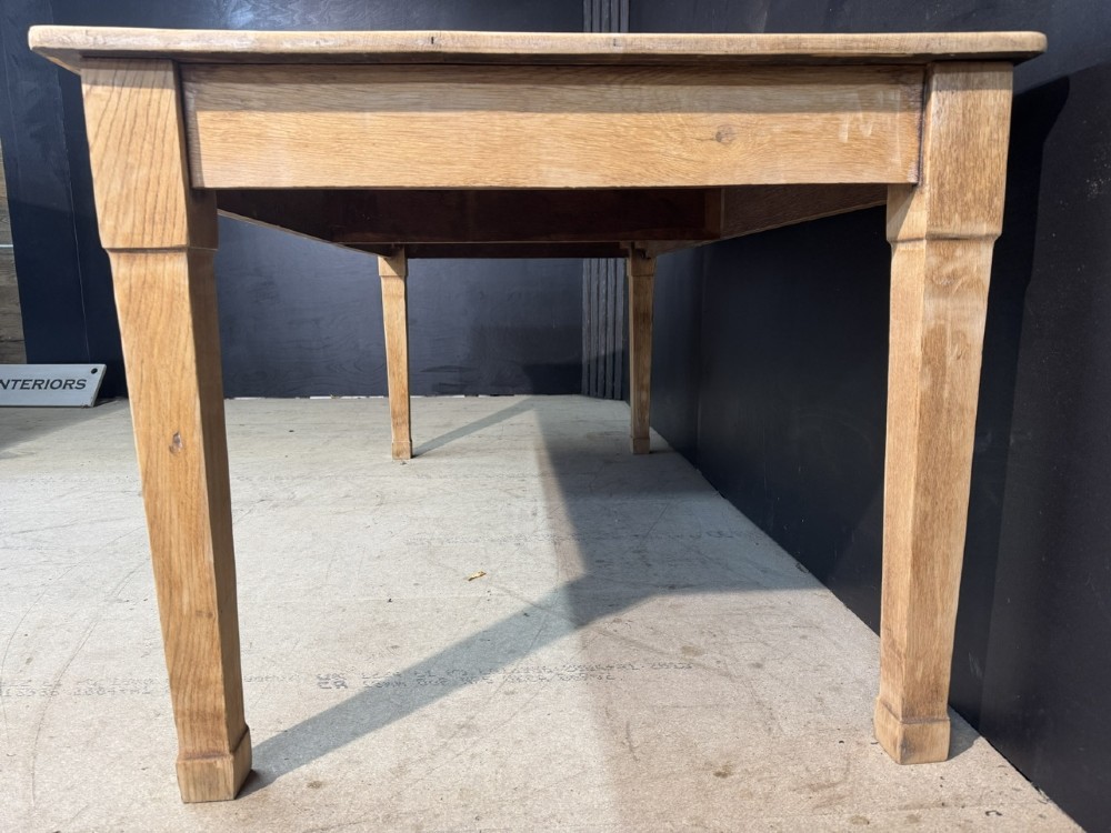 A rectangular light oak dining table featuring clean straight edges, a planked top, and simple tapered legs against a neutral background. View IX