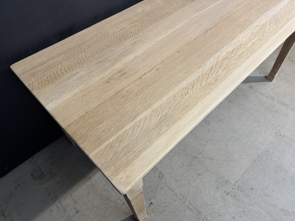 A rectangular light oak dining table featuring clean straight edges, a planked top, and simple tapered legs against a neutral background. View X