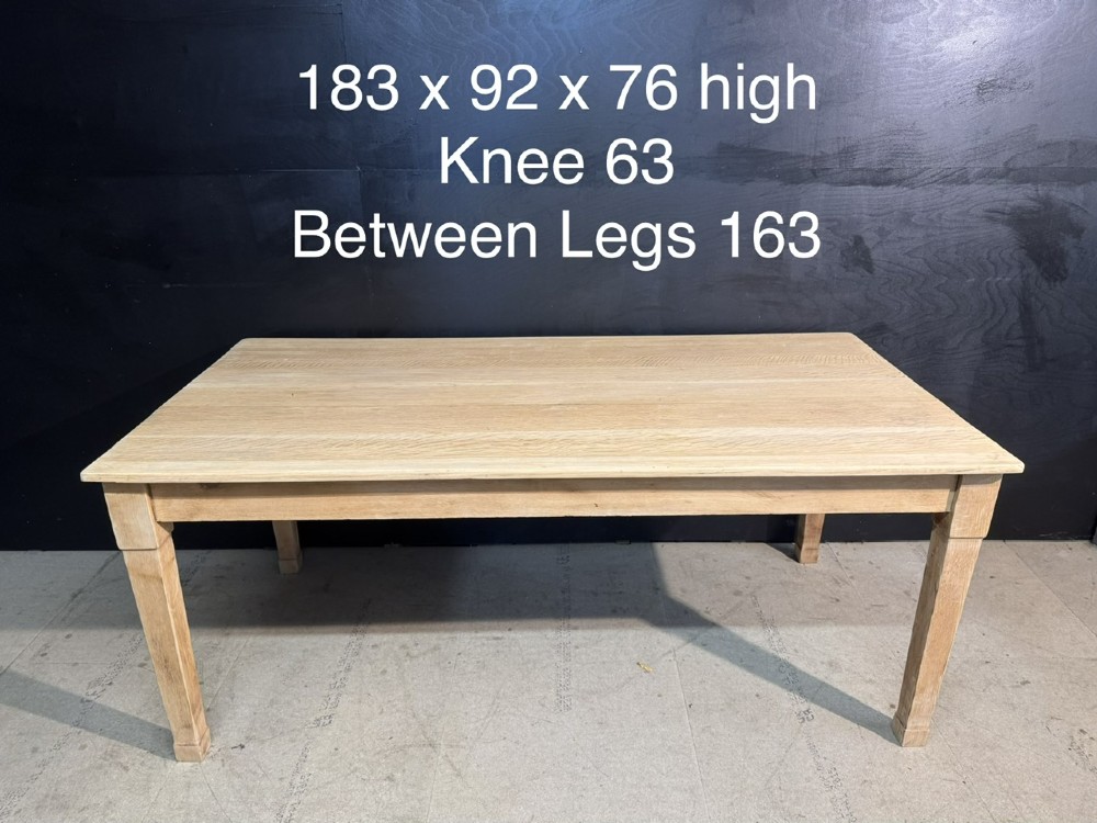A rectangular light oak dining table featuring clean straight edges, a planked top, and simple tapered legs against a neutral background. View XIV