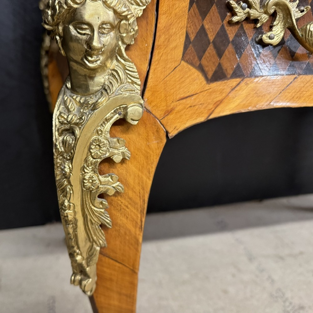 A French Louis XV style marquetry bureau plat featuring floral inlaid wood on the top surface, a diamond parquetry drawer frieze, gilt-bronze corner mounts, and curved cabriole legs. View XII