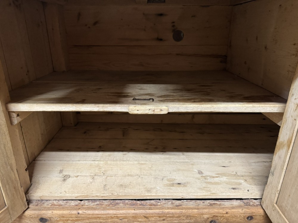 An antique country pine low cupboard featuring three top drawers over three panelled cupboard doors with turned wooden handles. View VII