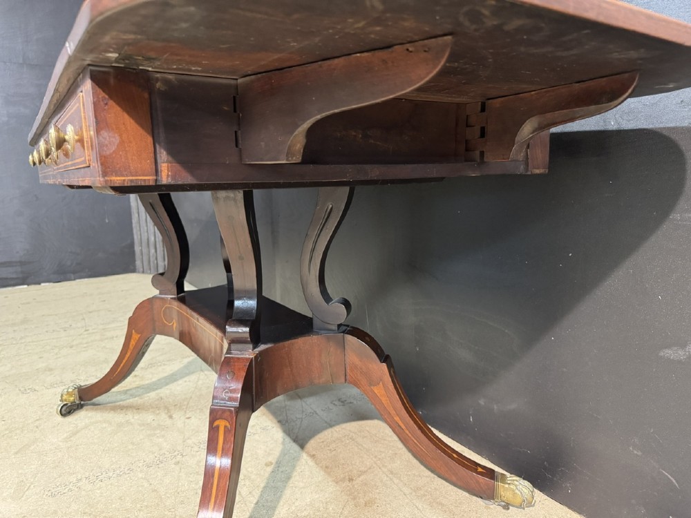A Georgian mahogany sofa table featuring two inline drawers with satinwood string inlay, drop leaves, twin-pillar supports, and splayed legs ending in brass claw feet on castors. View VIII