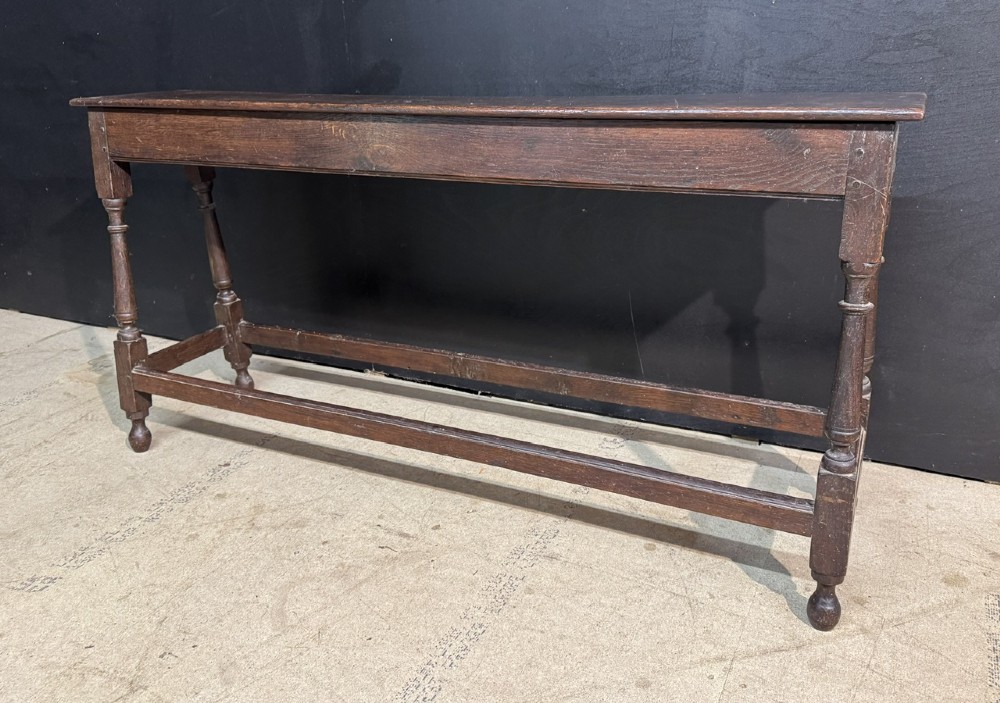 A long dark oak Georgian joint stool with turned legs, a rectangular top, and lower wooden stretchers. View III