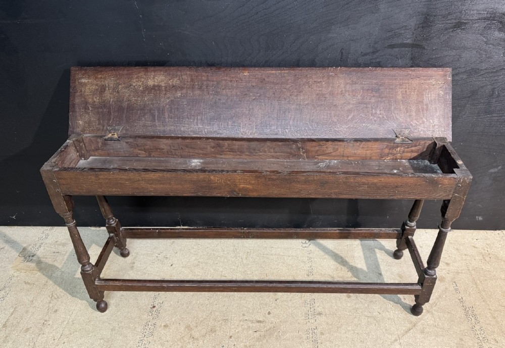 A long dark oak Georgian joint stool with turned legs, a rectangular top, and lower wooden stretchers. View V