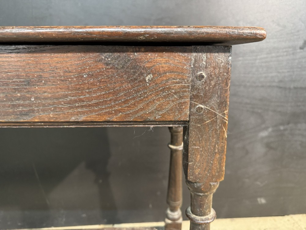 A long dark oak Georgian joint stool with turned legs, a rectangular top, and lower wooden stretchers. View VIII