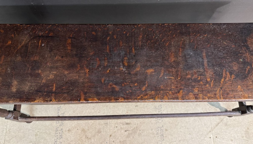 A long dark oak Georgian joint stool with turned legs, a rectangular top, and lower wooden stretchers. View XII