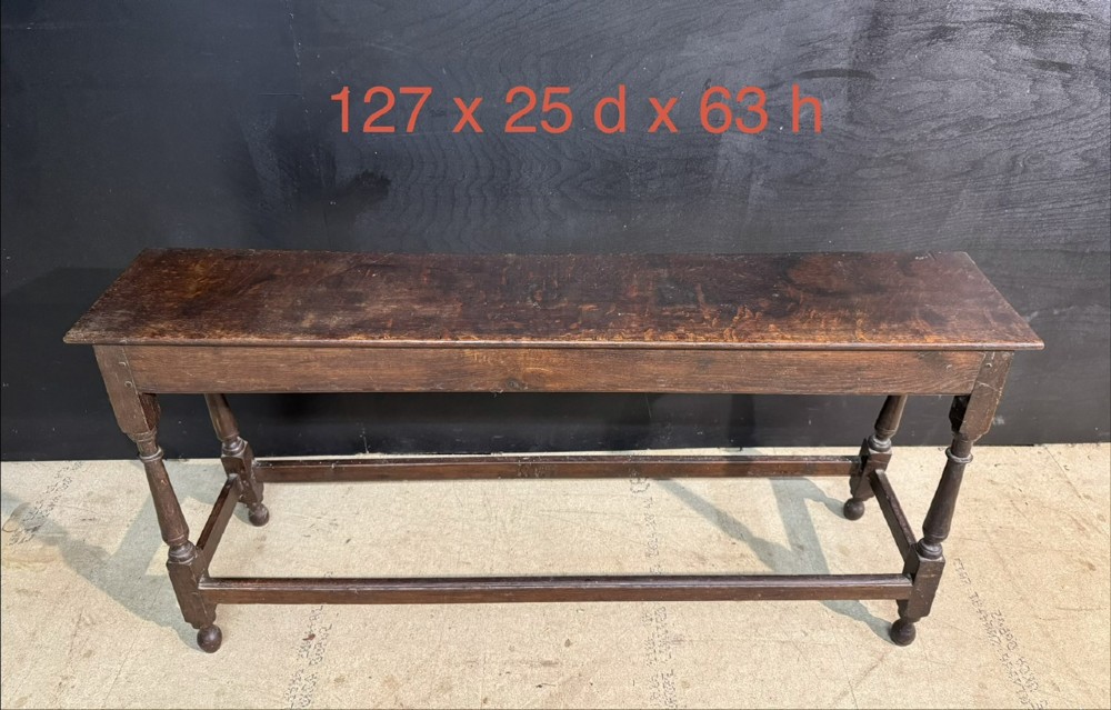 A long dark oak Georgian joint stool with turned legs, a rectangular top, and lower wooden stretchers. View XIII