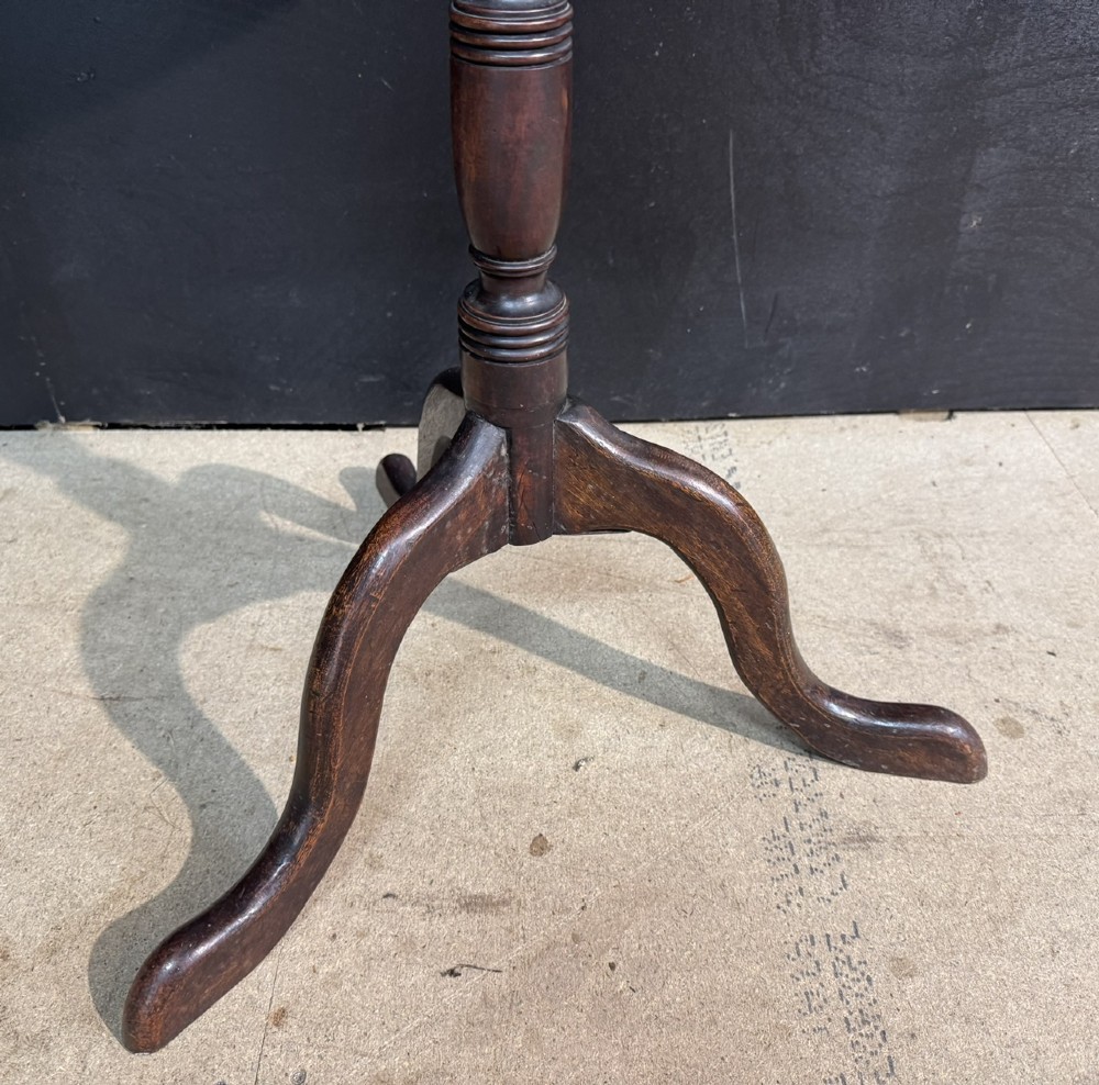 A Georgian mahogany tilt-top table featuring a circular top raised on a turned pedestal column and tripod cabriole legs. View VI