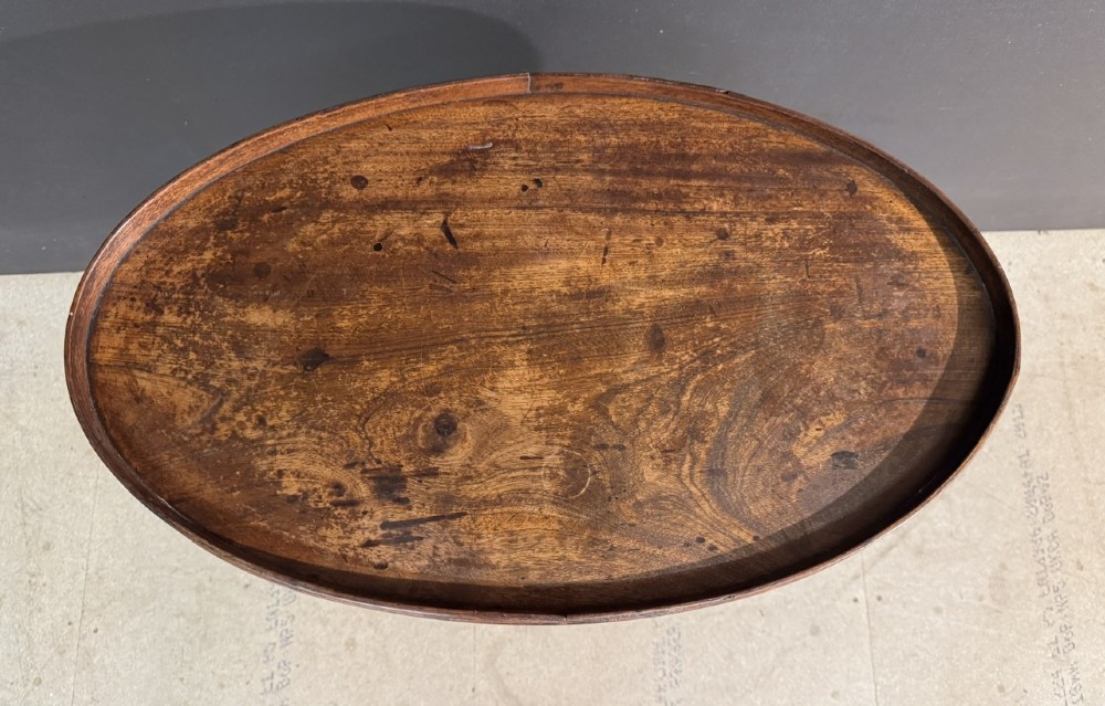 A Georgian mahogany tilt-top table featuring a circular top raised on a turned pedestal column and tripod cabriole legs. View VII