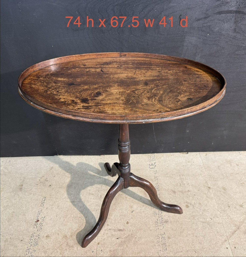 A Georgian mahogany tilt-top table featuring a circular top raised on a turned pedestal column and tripod cabriole legs. View VIII