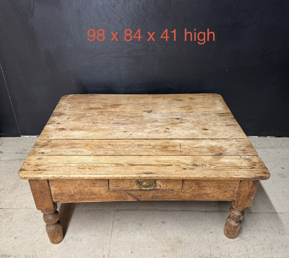 A low rectangular rustic pine coffee table featuring a plank top, turned corner legs, and a single central drawer with a brass drop handle. View VIII