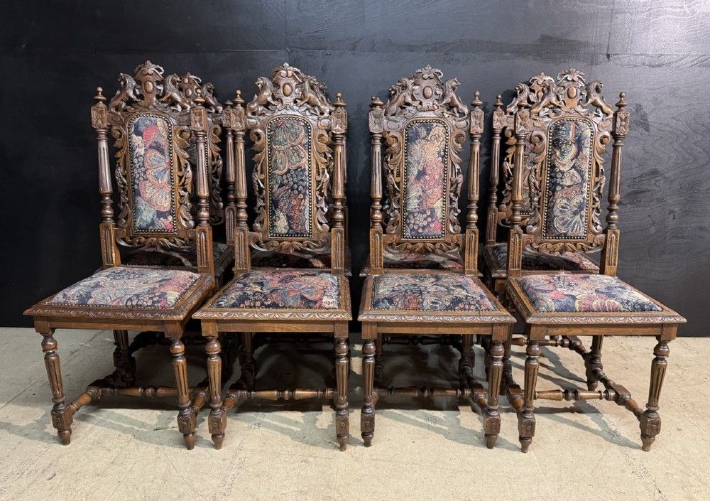A set of eight high-backed dark oak dining chairs featuring carved lion crests and tapestry fabric upholstery. View II