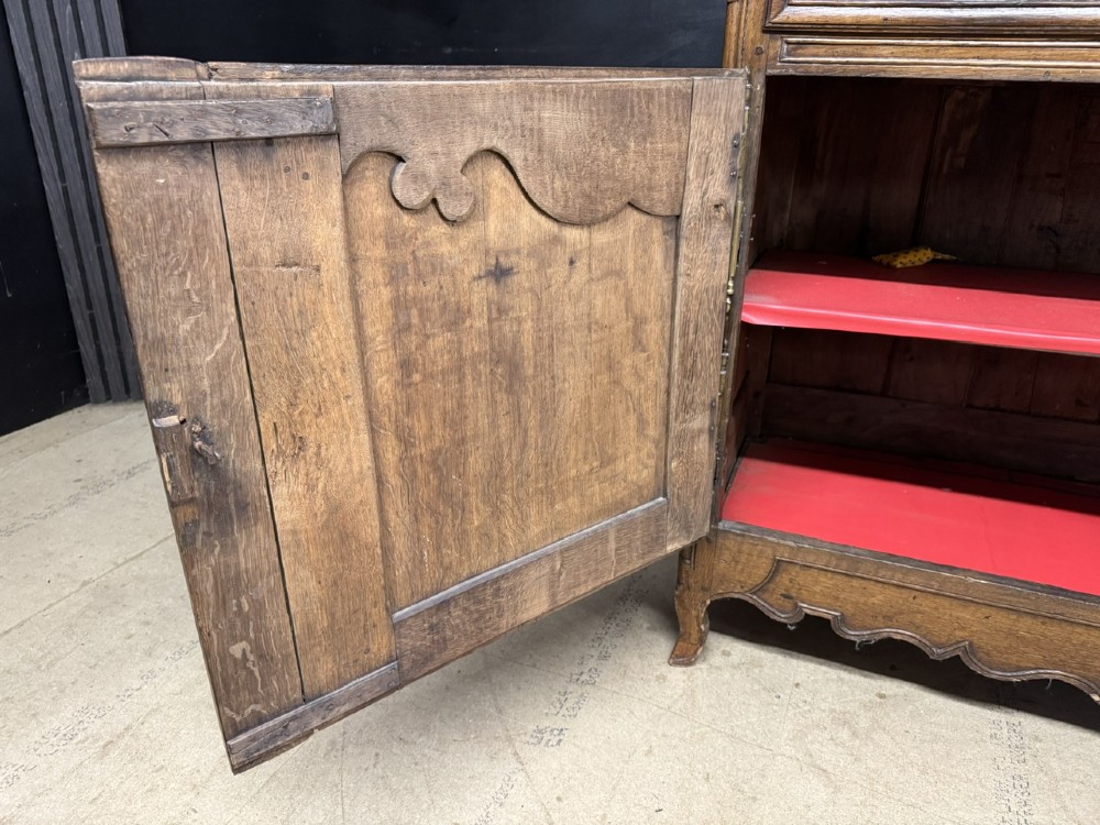 An 18th-century French provincial oak buffet featuring three top drawers above two carved panel doors with brass hardware. View X
