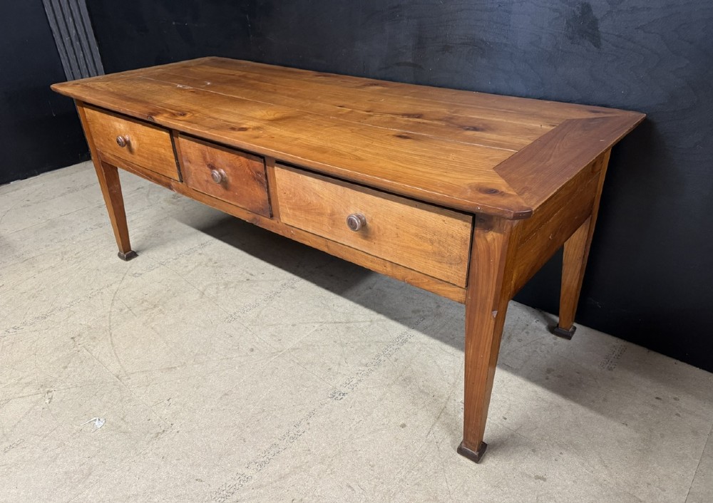 An 18th-century French provincial wooden console table featuring three frieze drawers with wooden turned knobs and four tapered square legs. View IV