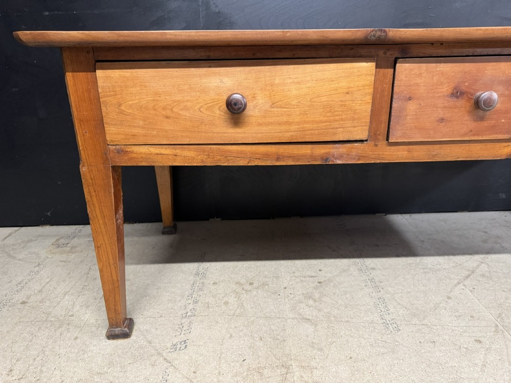 An 18th-century French provincial wooden console table featuring three frieze drawers with wooden turned knobs and four tapered square legs. View VI