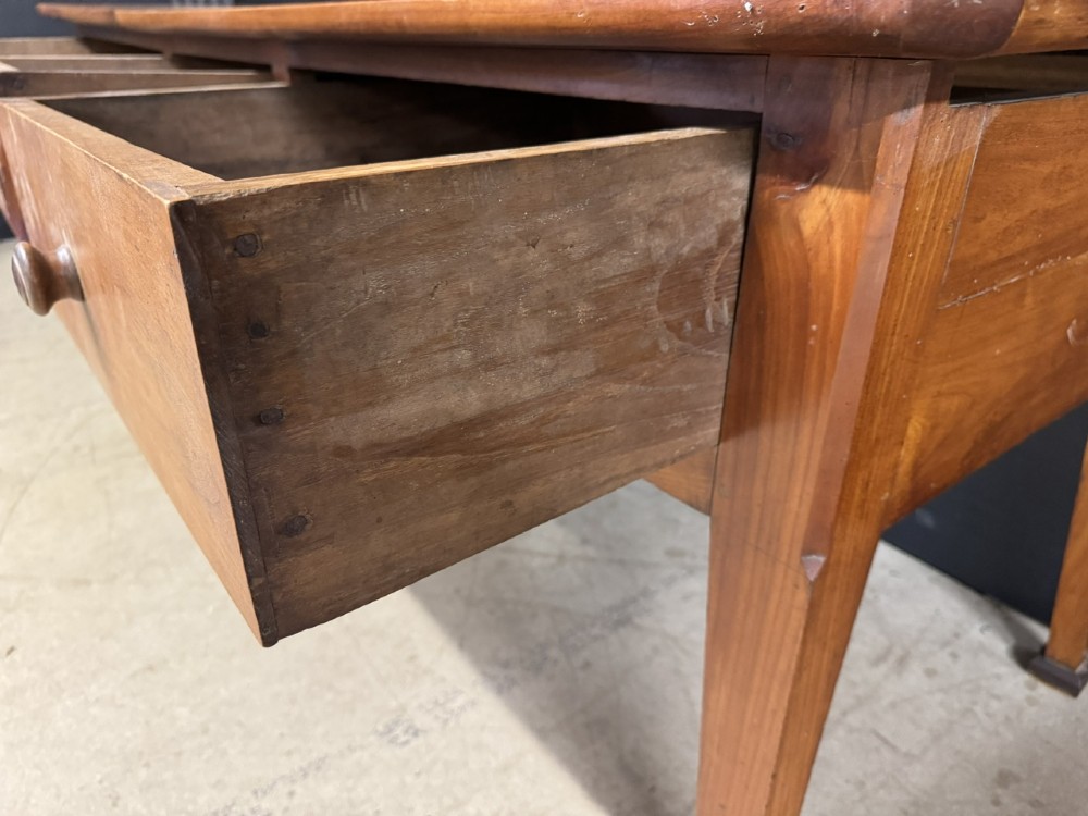 An 18th-century French provincial wooden console table featuring three frieze drawers with wooden turned knobs and four tapered square legs. View XII