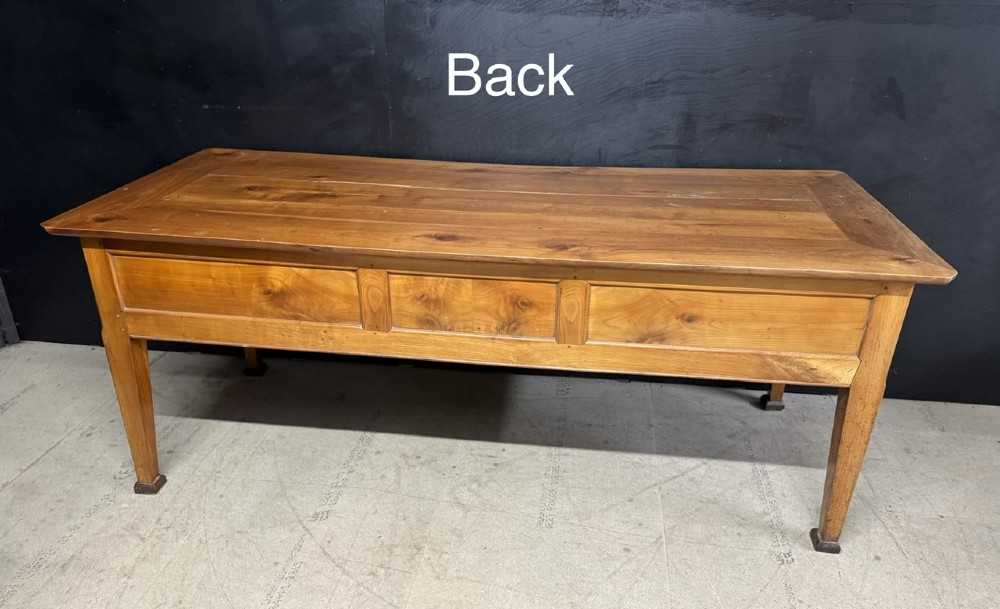 An 18th-century French provincial wooden console table featuring three frieze drawers with wooden turned knobs and four tapered square legs. View XV