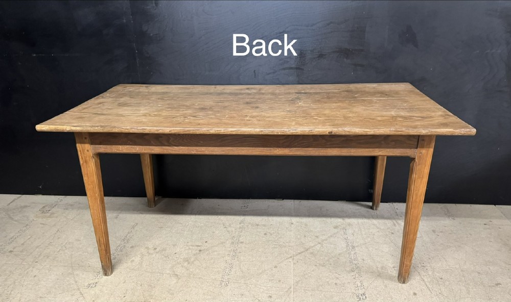 A rectangular natural oak French Normandy country table featuring a simple plank top, tapered legs, and a single frieze drawer. View X