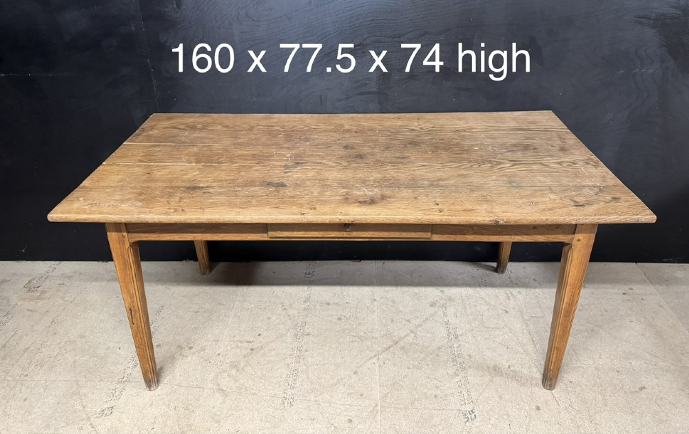 A rectangular natural oak French Normandy country table featuring a simple plank top, tapered legs, and a single frieze drawer. View XII