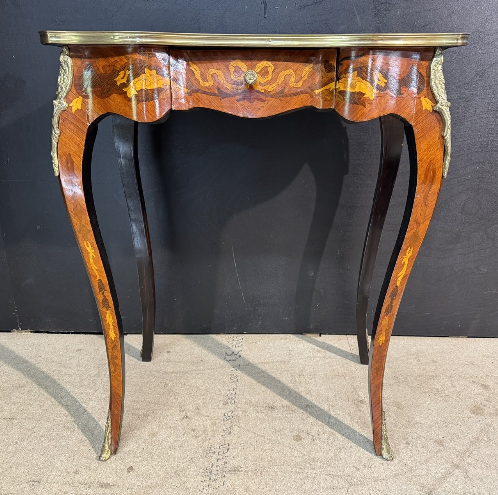 A French Louis XV style marquetry side table featuring cabriole legs, decorative brass mounts, and detailed floral wood inlay across the serpentine top and drawer. View VI