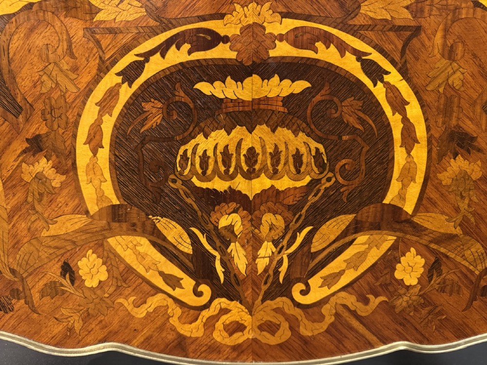 A French Louis XV style marquetry side table featuring cabriole legs, decorative brass mounts, and detailed floral wood inlay across the serpentine top and drawer. View X