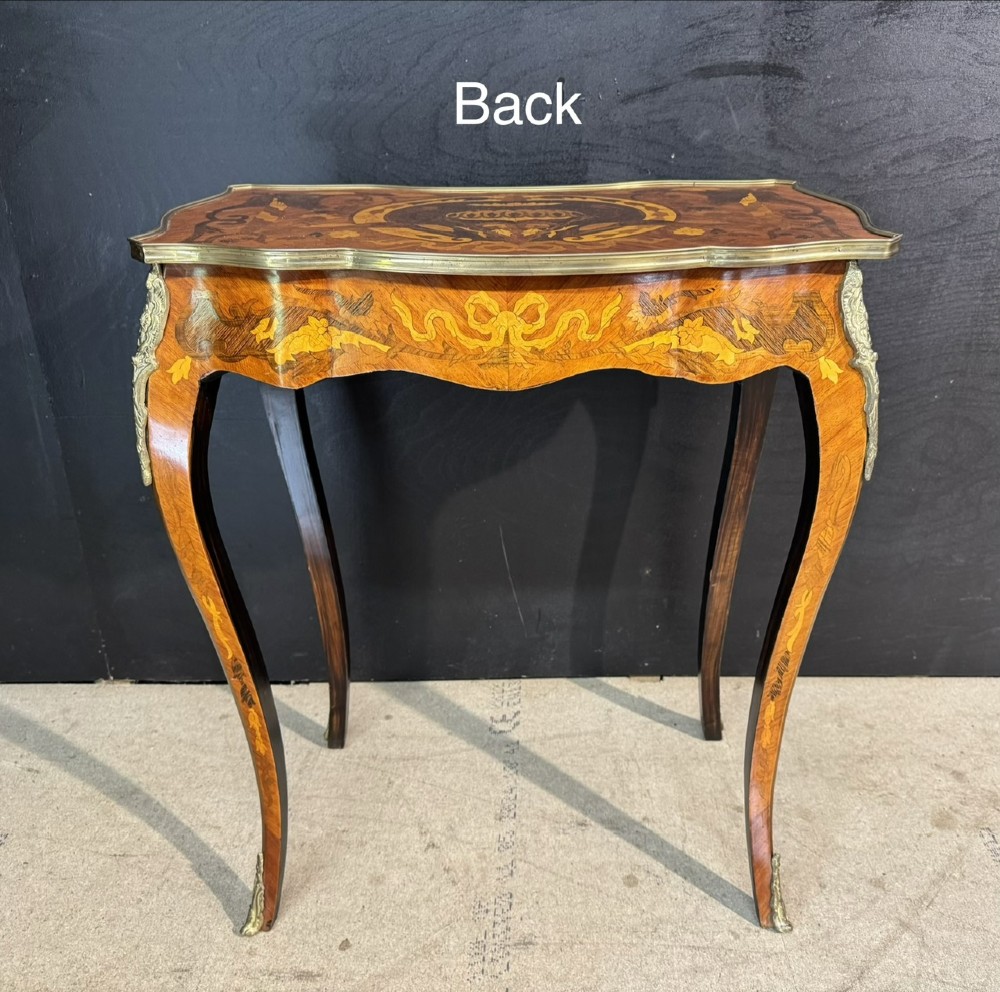 A French Louis XV style marquetry side table featuring cabriole legs, decorative brass mounts, and detailed floral wood inlay across the serpentine top and drawer. View XI