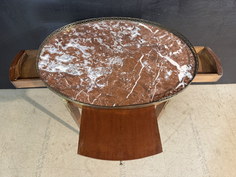 An oval French side table featuring a red veined marble top with a pierced brass gallery, geometric parquetry apron, and four tapered legs adorned with brass mounts. View VII