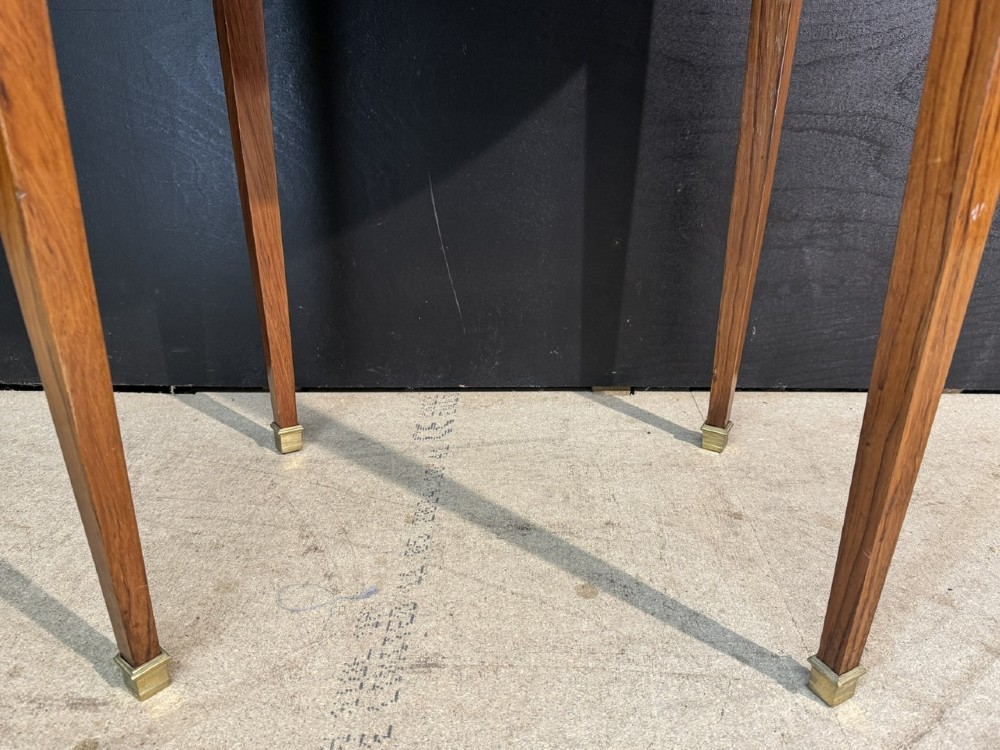 An oval French side table featuring a red veined marble top with a pierced brass gallery, geometric parquetry apron, and four tapered legs adorned with brass mounts. View XIV