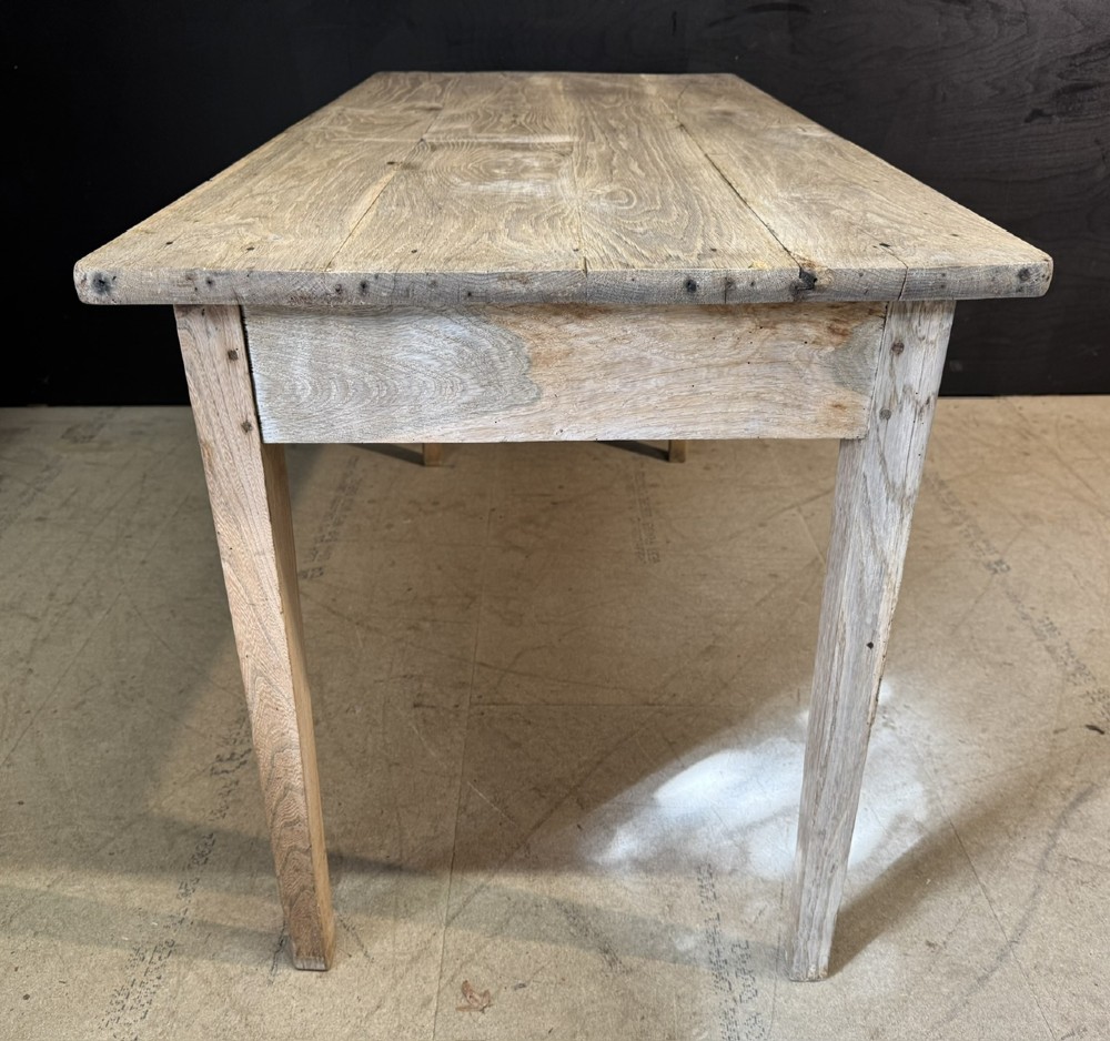 A rustic light oak French Normandy table featuring a flat plank top, a single central frieze drawer with a metal knob, and four square tapered legs. View IX