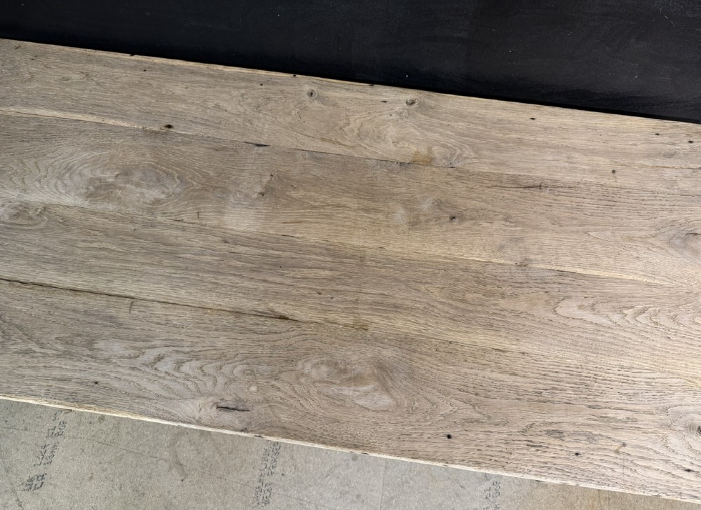 A rustic light oak French Normandy table featuring a flat plank top, a single central frieze drawer with a metal knob, and four square tapered legs. View XI
