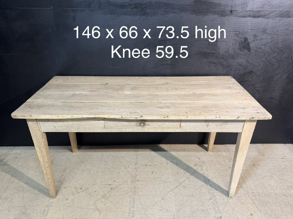 A rustic light oak French Normandy table featuring a flat plank top, a single central frieze drawer with a metal knob, and four square tapered legs. View XII