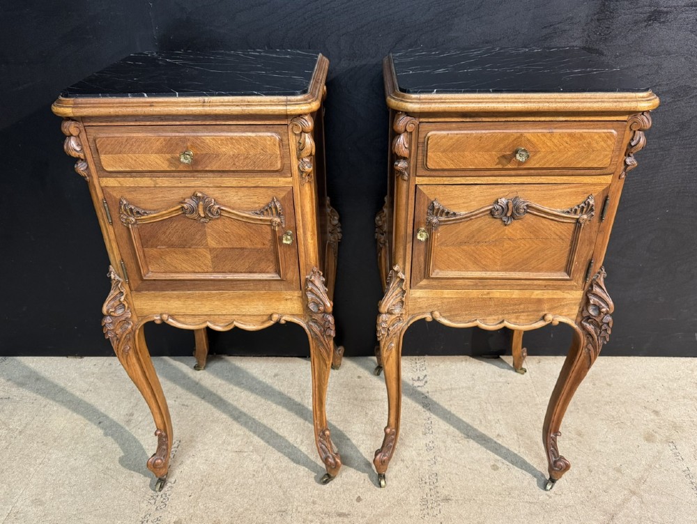A pair of French walnut bedside cabinets with carved cabriole legs, dark marble tops, single drawers, and cupboard doors. View IV