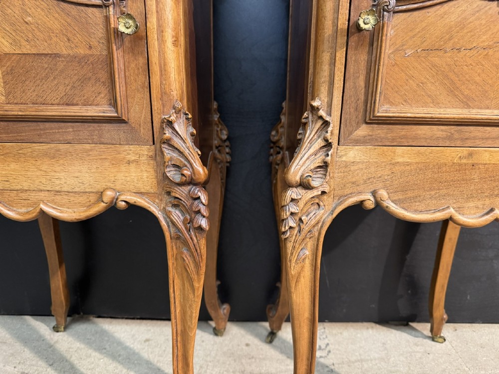 A pair of French walnut bedside cabinets with carved cabriole legs, dark marble tops, single drawers, and cupboard doors. View X