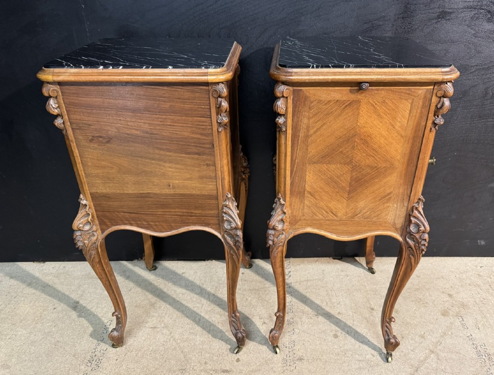 A pair of French walnut bedside cabinets with carved cabriole legs, dark marble tops, single drawers, and cupboard doors. View XI