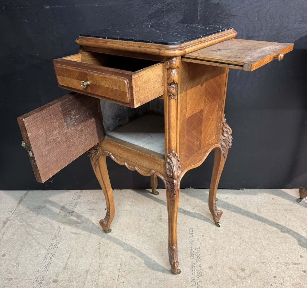 A pair of French walnut bedside cabinets with carved cabriole legs, dark marble tops, single drawers, and cupboard doors. View XIV