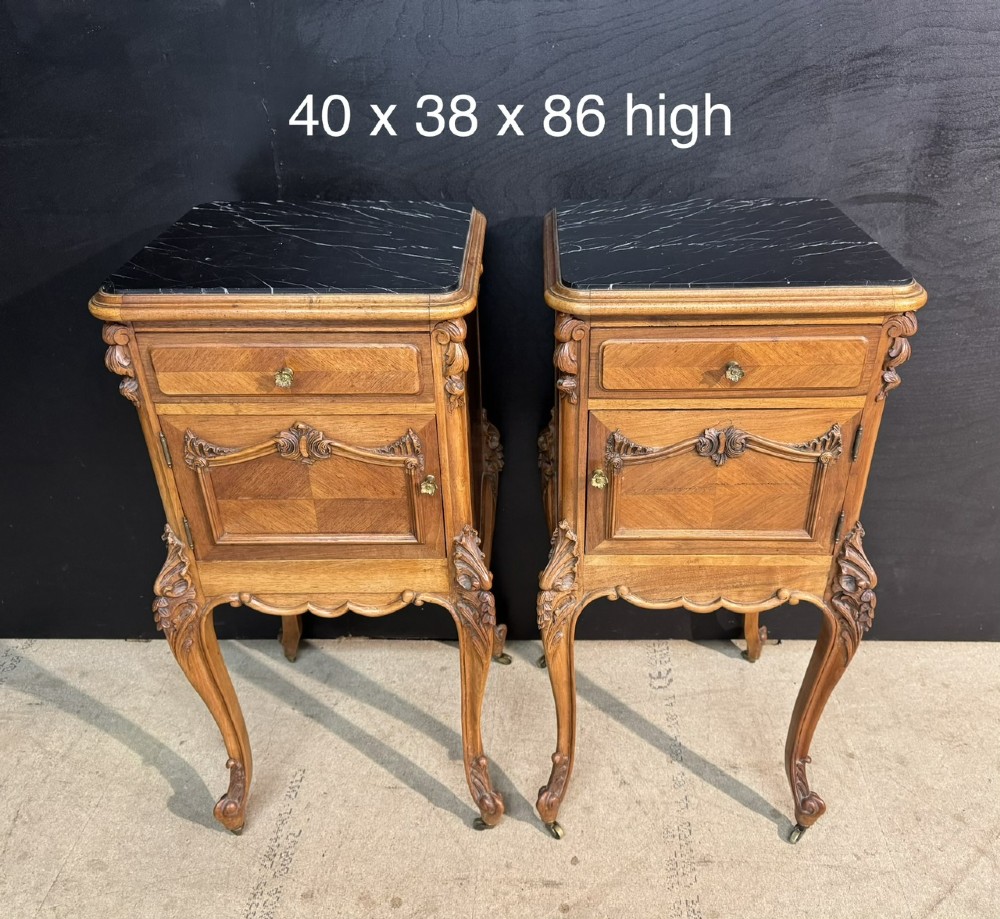 A pair of French walnut bedside cabinets with carved cabriole legs, dark marble tops, single drawers, and cupboard doors. View XV