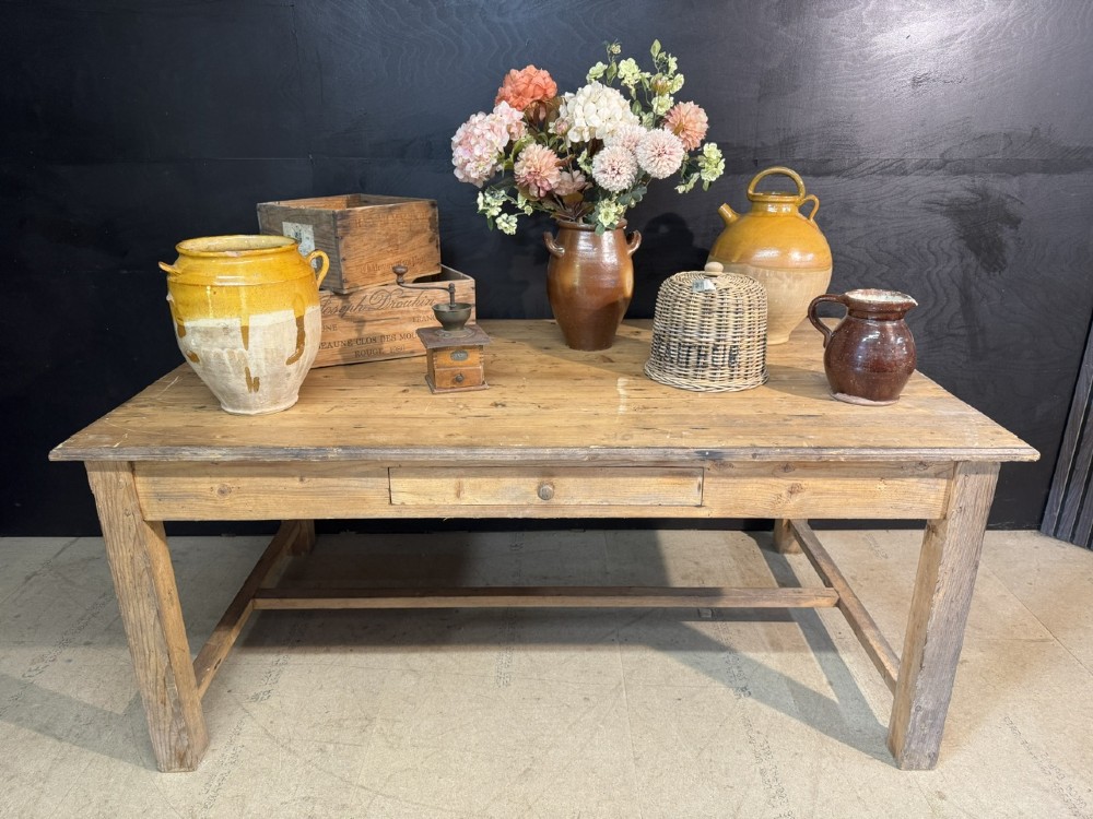 A rustic natural pine farmhouse kitchen table featuring a plank top, a single apron drawer, square legs, and a low stretcher base. View II