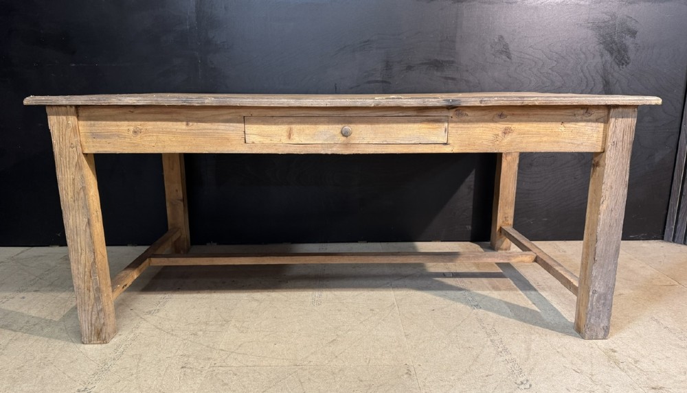 A rustic natural pine farmhouse kitchen table featuring a plank top, a single apron drawer, square legs, and a low stretcher base. View IV