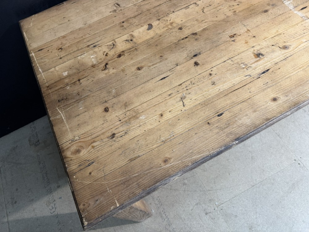 A rustic natural pine farmhouse kitchen table featuring a plank top, a single apron drawer, square legs, and a low stretcher base. View VI