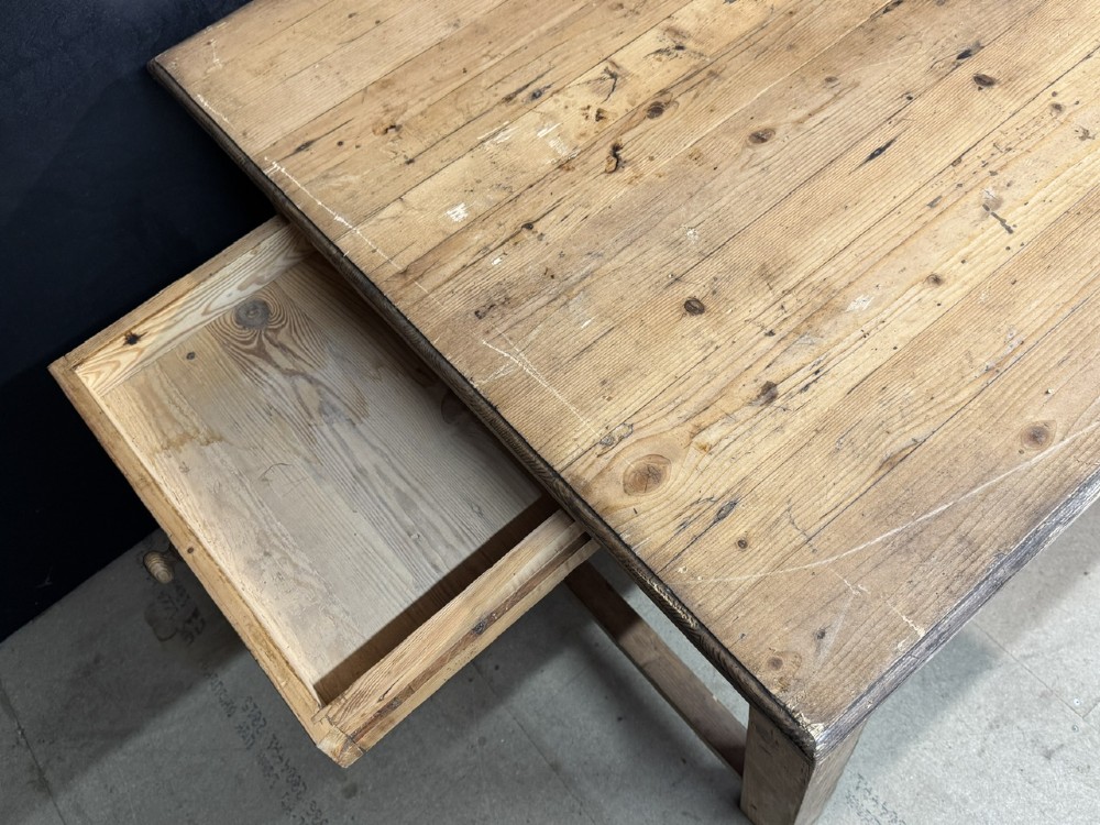 A rustic natural pine farmhouse kitchen table featuring a plank top, a single apron drawer, square legs, and a low stretcher base. View IX