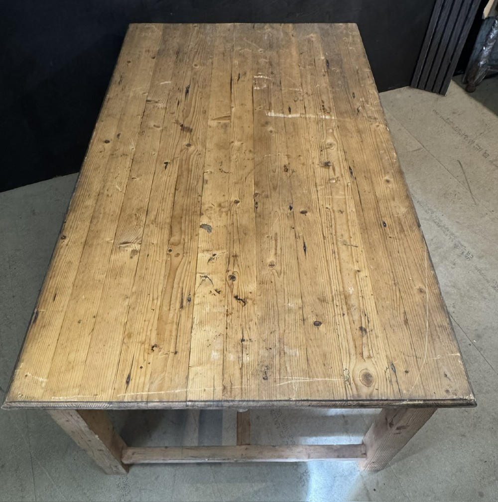 A rustic natural pine farmhouse kitchen table featuring a plank top, a single apron drawer, square legs, and a low stretcher base. View XI