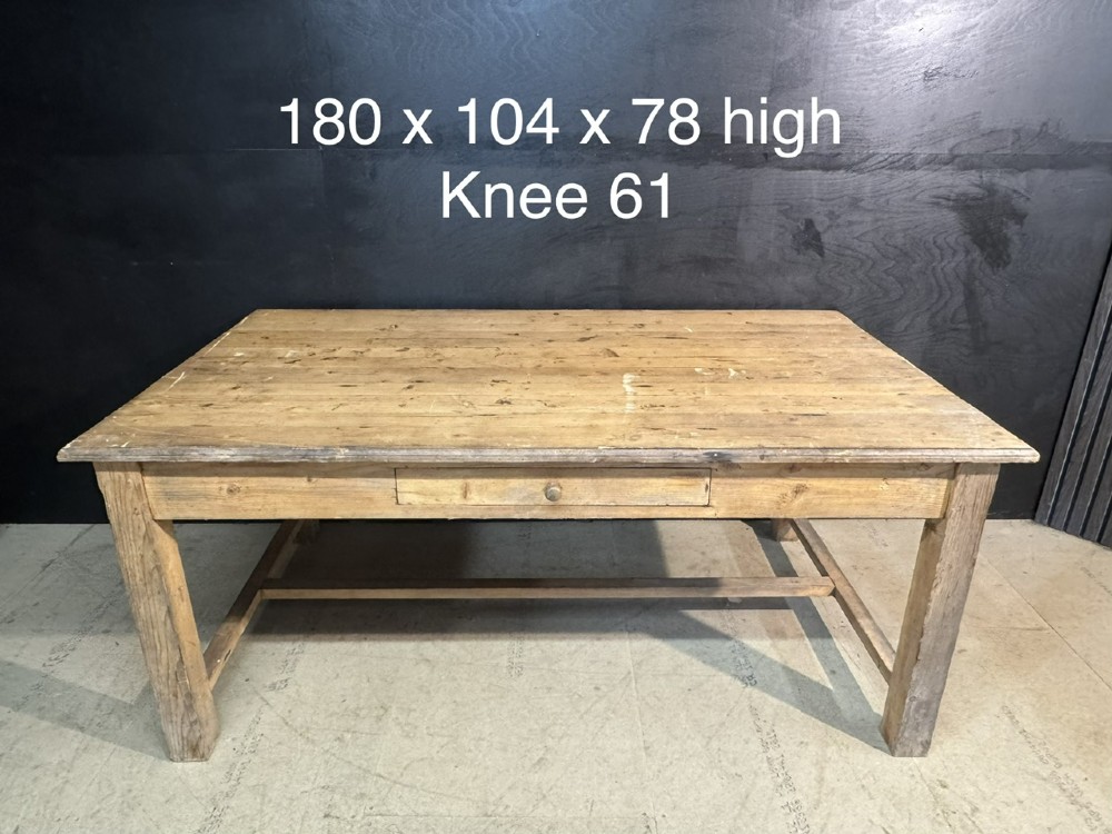 A rustic natural pine farmhouse kitchen table featuring a plank top, a single apron drawer, square legs, and a low stretcher base. View XIV