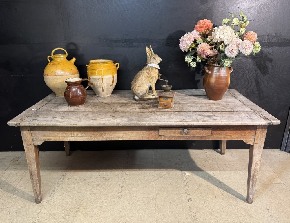 A rustic French provincial kitchen table featuring a scrubbed timber plank top, a single frieze drawer with a small knob, and four tapered square legs. View II