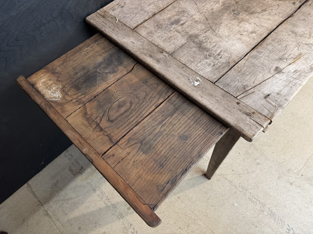 A rustic French provincial kitchen table featuring a scrubbed timber plank top, a single frieze drawer with a small knob, and four tapered square legs. View VI