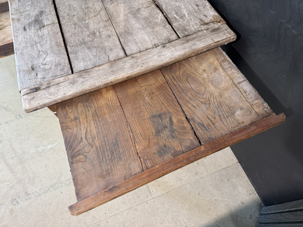 A rustic French provincial kitchen table featuring a scrubbed timber plank top, a single frieze drawer with a small knob, and four tapered square legs. View VII