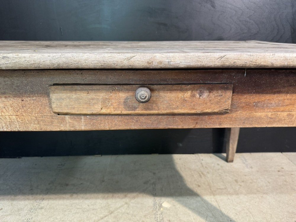 A rustic French provincial kitchen table featuring a scrubbed timber plank top, a single frieze drawer with a small knob, and four tapered square legs. View IX