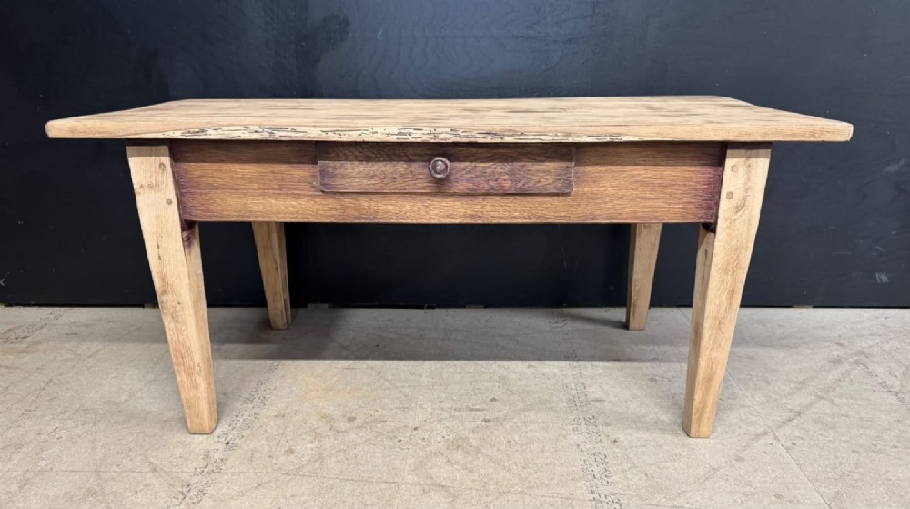 A low French oak coffee table with a rectangular light wood plank top, a single frieze drawer, and tapered square legs. View II